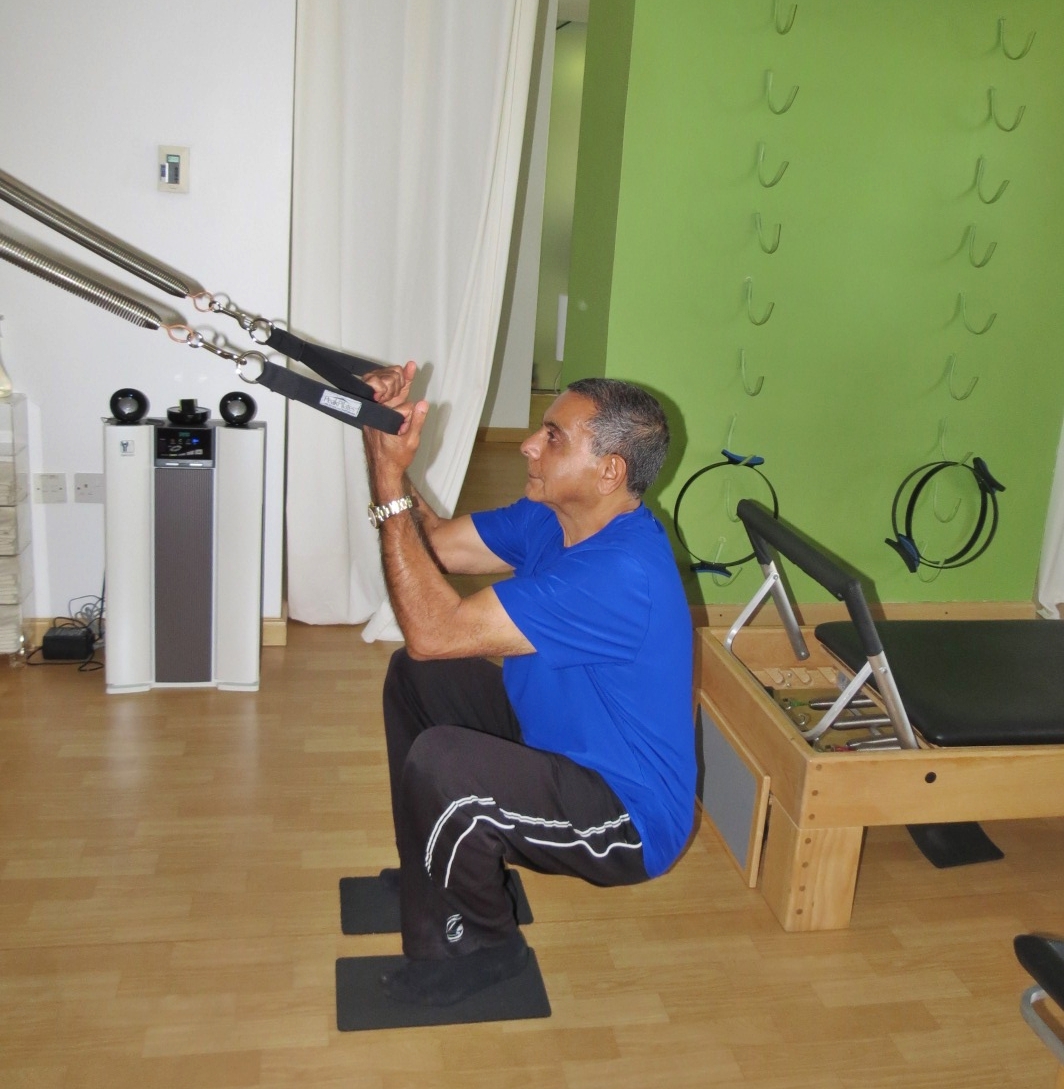 Moe Kassam at the Hundred Pilates Studio and under Jeanique's expert guidance as he trains on the reformer machine. | www.thehundred.ae 